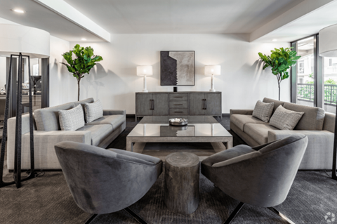 a living room with couches and chairs and a coffee table